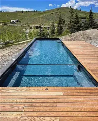 A pool with a wooden pool deck