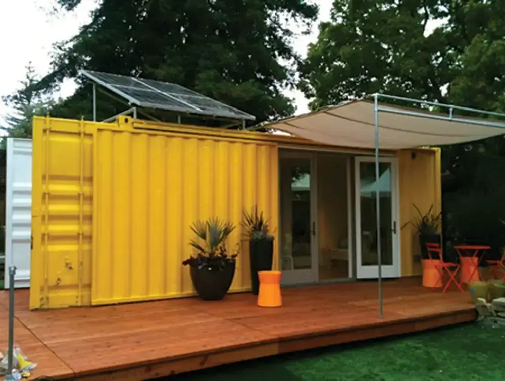 A yellow modular container home by HyBrid Architecture.
