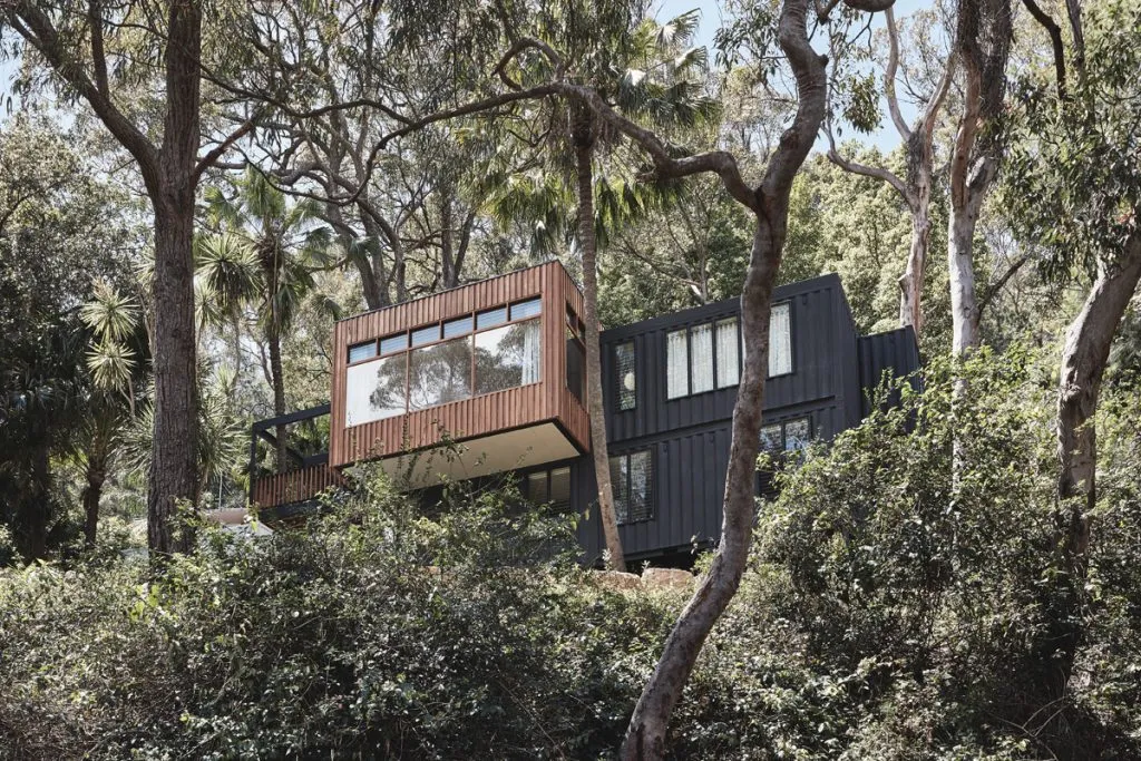 A container home in a forest.