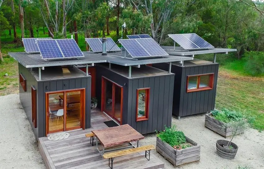 A container home with a solar panel on the roof