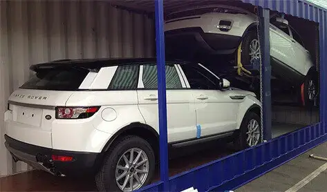 A shipping container with cars inside ready to be shipped to different places