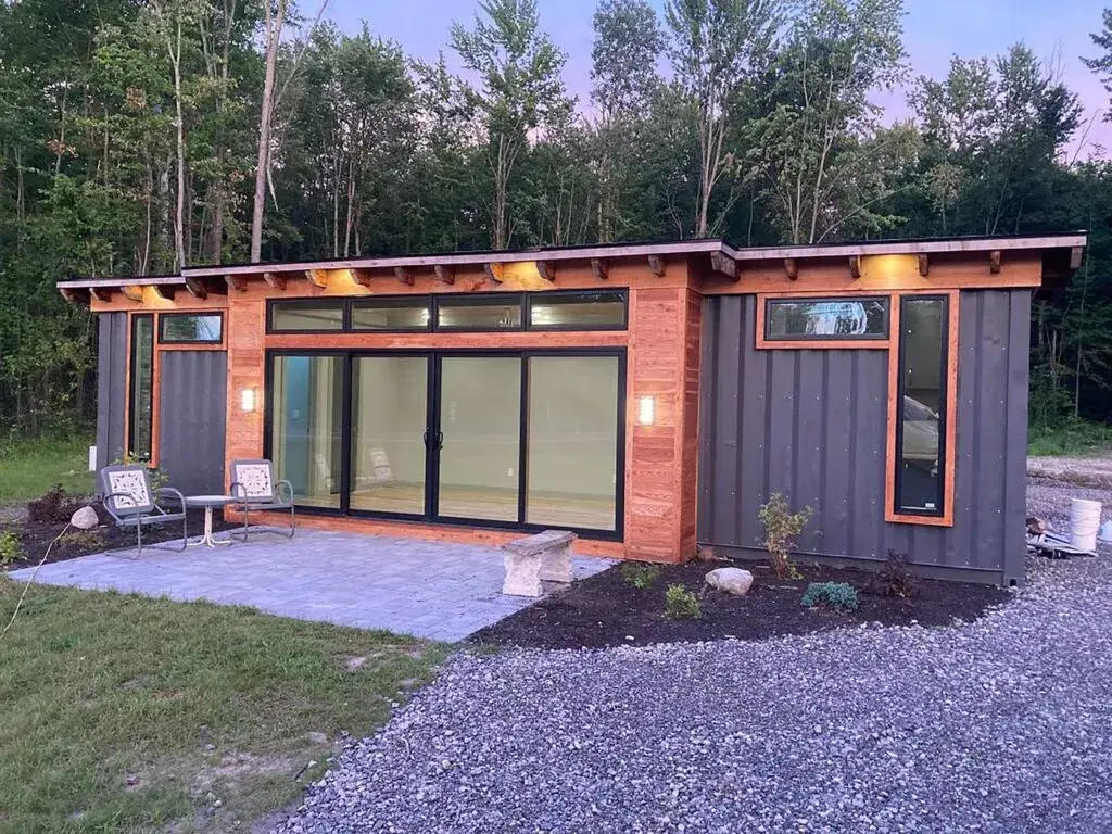 A standard shipping container home with a beautiful surrounding