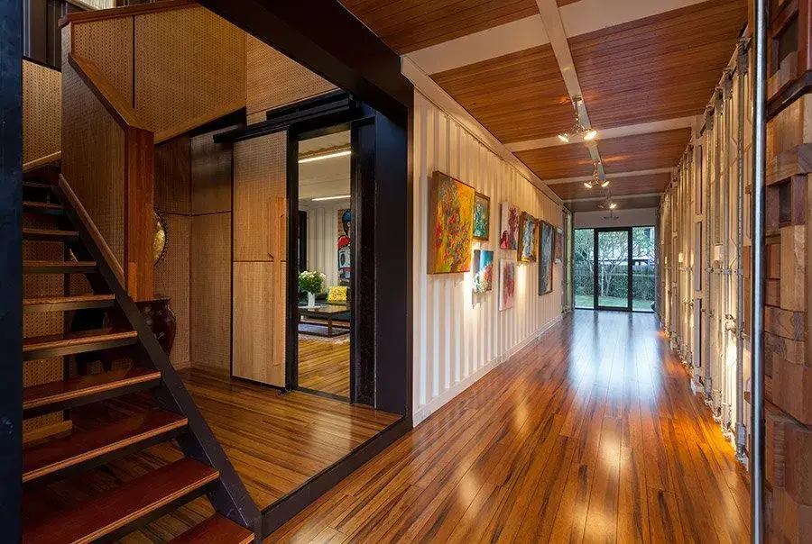 A shipping container home fitted with wooden floor as an interior design option