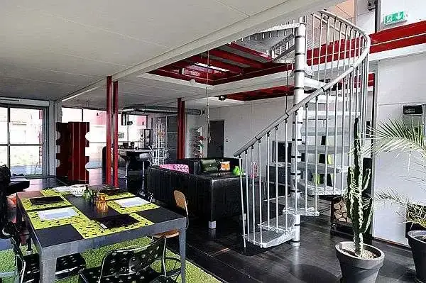 Two storey shipping container home with spiral staircase by Manuel DJAMDJIAN