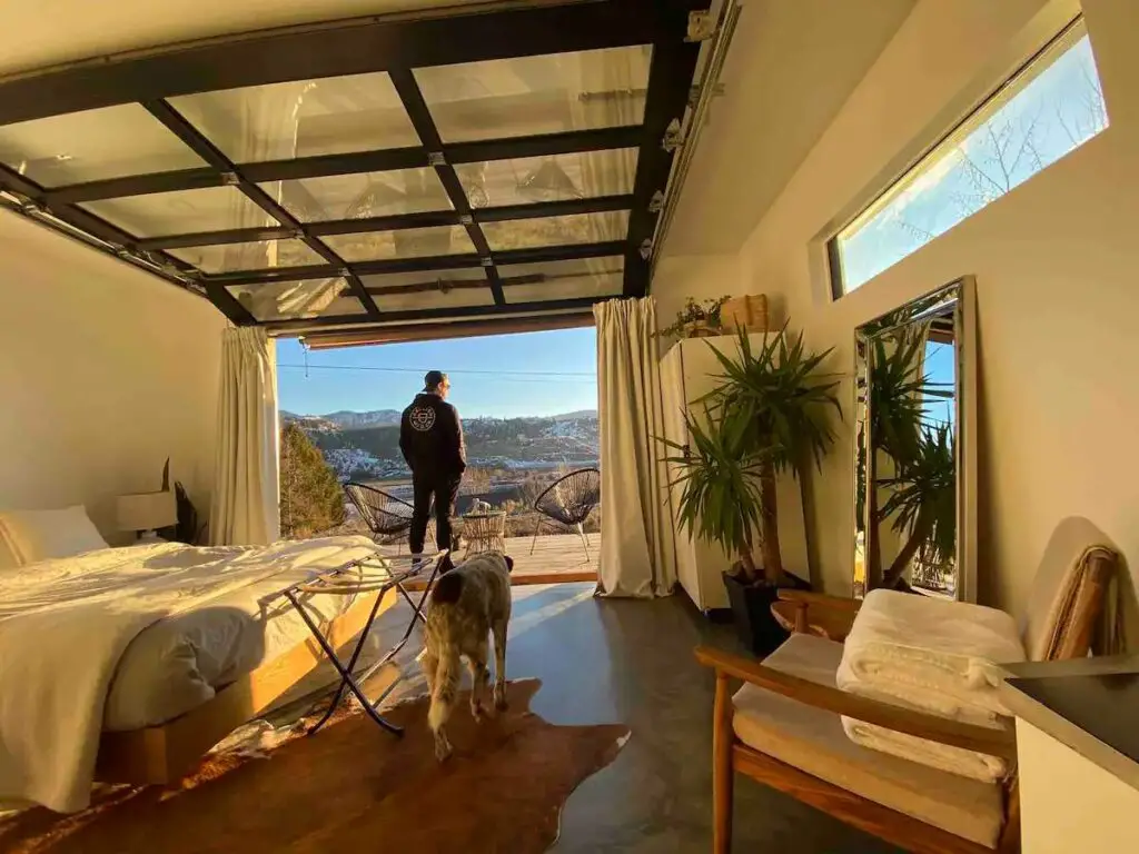 Master bedroom of a shipping container home in Kamloops, British Columbia, Canada with a garage door