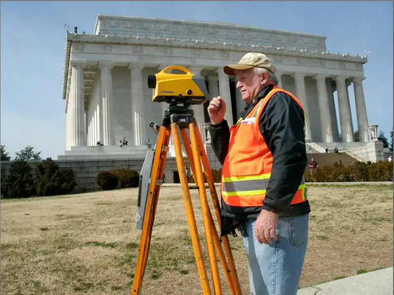A surveyor from NOAA's National Geodetic Survey measures the difference in elevation between two points